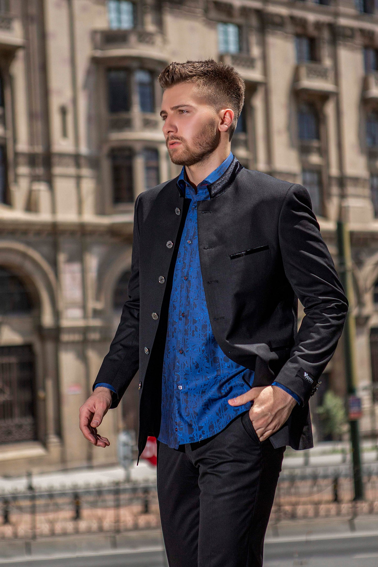 Bold banded black suit with navy blue shirt