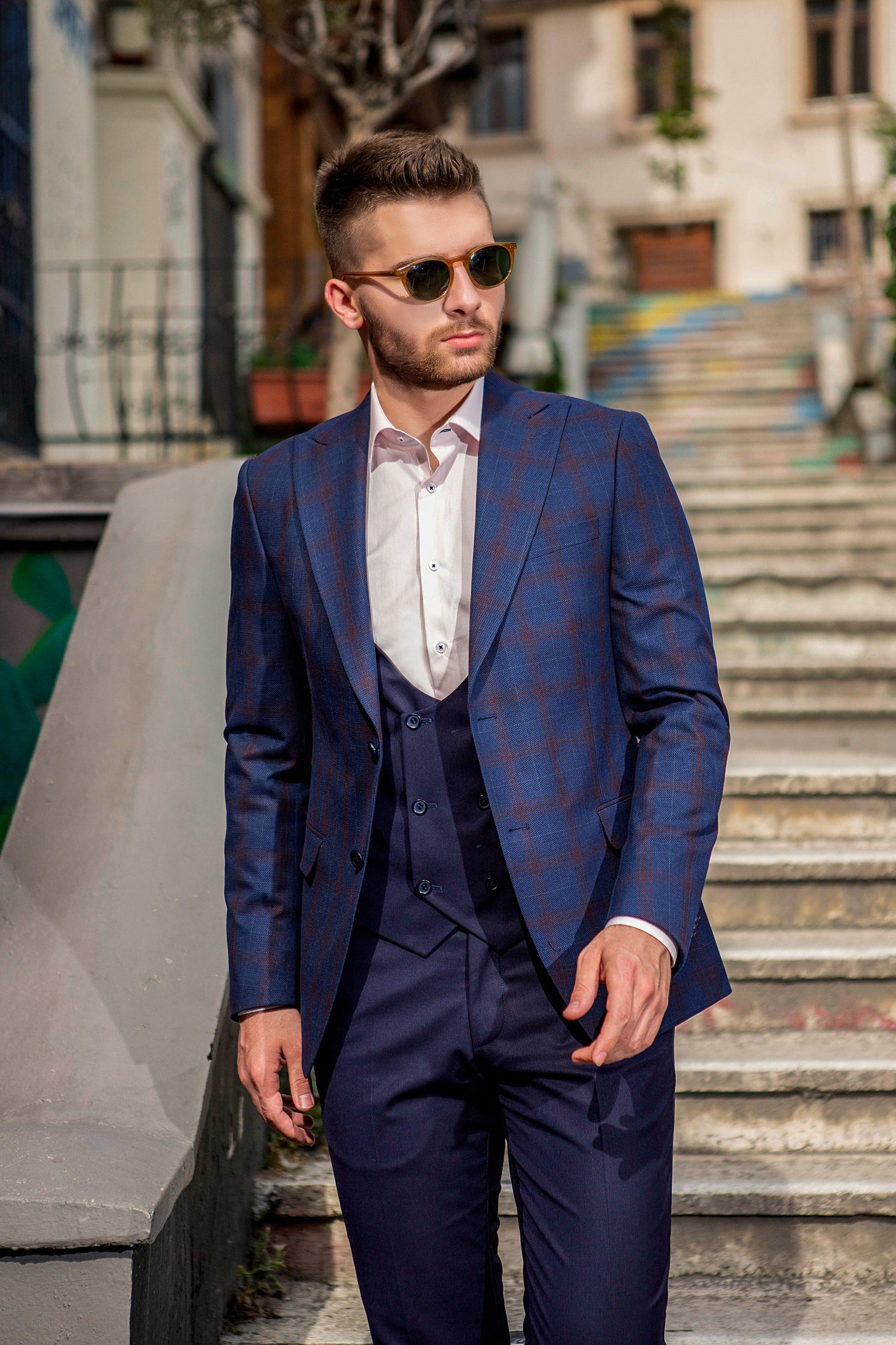 Tartan-Navy-Plaid, 3-Piece suit with complementing dark-red lines. Suit is made from premium wool and has a notched lapel. 