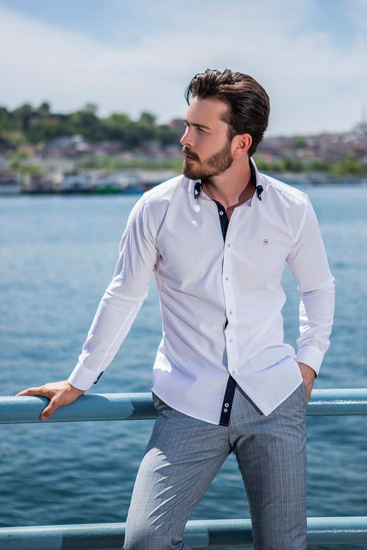 Slim white dress shirt with embesselment detail and a dark blue interlining. Small Valenti Moda logo patch on right chest.